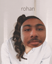 a man with a ponytail and a mustache has the name rohan above him