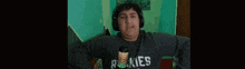 a man wearing headphones and a shirt that says rokies on it