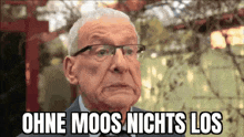 an elderly man wearing glasses and a suit is making a funny face and says ohne moos nichts los .