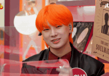a young man with orange hair is standing in front of a sign that says the lost soulmate