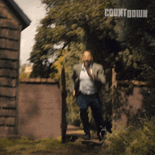 a man in a suit is running with the word countdown on the bottom right