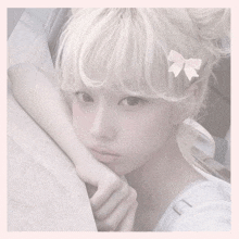 a girl with white hair has a pink bow on her hair