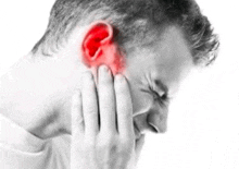 a man is holding his ear because he has a headache .