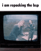 two women are dancing in front of a tv screen that says " i am repacking the bsp "
