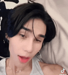 a close up of a person 's face with the letters tiktok on the bottom
