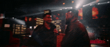 two men are shaking hands in a dark room with the word brothers on the bottom