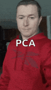 a man in a red hoodie with the word pca written on his face
