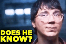 a close up of a man with glasses and the words " does he know "