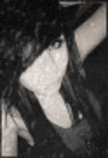a black and white photo of a woman with blue eyes and black hair