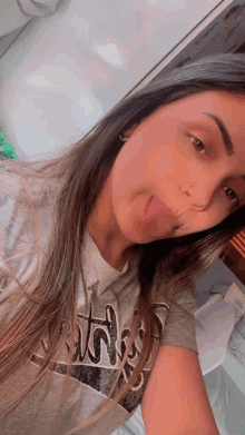a girl wearing a grey shirt with the word bitch on it