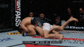 two men are wrestling in a cage with ufc 2:12 on the clock