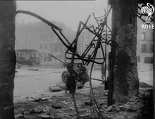a black and white photo of a destroyed building with the pathe logo