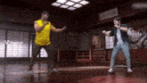 a man in a yellow shirt is dancing with another man