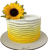 a yellow and white cake with a sunflower on top of it sits on a plate that says mica