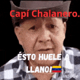 a man wearing a cowboy hat and plaid shirt says capi chalanero