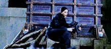 a woman is holding a gun while sitting on a dragon statue