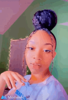 a girl with a bun on her head is wearing a shirt that says momento