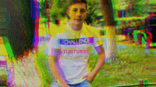 a man wearing a shirt that says challenge torture is standing in a park