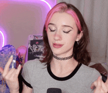 a girl with pink hair is wearing a choker