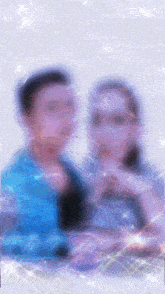 a blurry picture of a man and woman with a square in the middle of their faces
