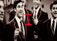 a group of men in suits and ties are standing in front of a sign that says i.