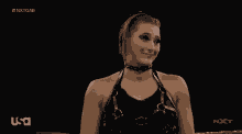 a female wrestler is smiling while wearing a choker on a usa broadcast