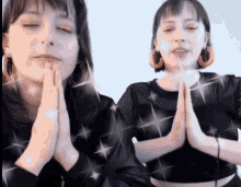 two women are praying with their hands together
