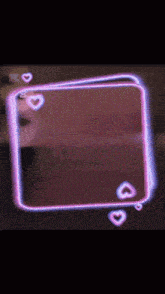 a pink square with hearts on it and a black background