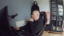 a man sits in a chair with the word still on the back