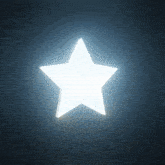 a white star is glowing in the dark with a dark background