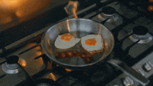 eggs are being cooked on a stove with flames coming out of the pan