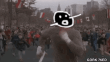 a man is running in front of a crowd of people in a crowded street .
