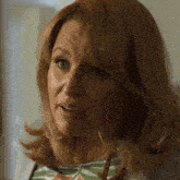 a close up of a woman 's face with a serious expression