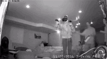 a man wearing a virtual reality headset is playing a video game in a living room .
