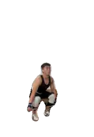a man in a black and white outfit is jumping in the air