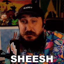 a man with a beard wearing a hat that says daddy