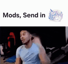 a man in a blue shirt is sitting in front of a screen that says " mods send in "