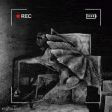 a black and white photo of a statue with a red rec button