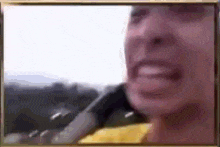a close up of a person 's face with a blurred background .