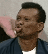 a man is making a funny face with his mouth open and his tongue sticking out .