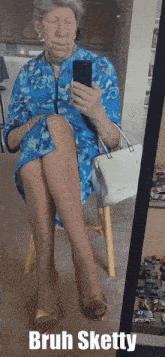 a woman is taking a selfie in front of a mirror with the caption bruh sketty