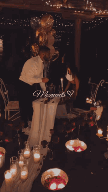 a couple sitting at a table with candles and the words moments written on the bottom right
