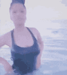 a blurry picture of a woman in a bathing suit in a pool