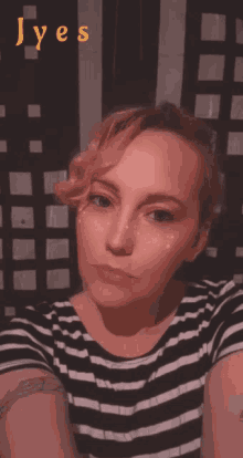 a woman in a striped shirt takes a selfie with the words " lyes " written above her