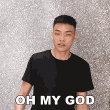 a young man in a black t-shirt says oh my god