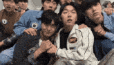 a group of young men are posing for a picture and one of them has a badge with the number 81 on it