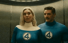 a man and a woman are standing next to each other in an elevator wearing superhero costumes .