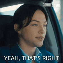 a woman is sitting in a car with the words yeah that 's right behind her
