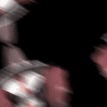 a blurred image of a red and white cloth with a black background