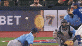 a baseball game is being played in front of a bet banner